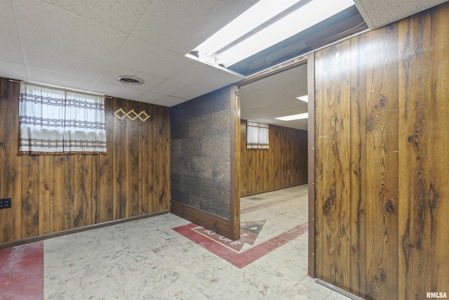 502 W Crestwood Dr, Peoria, IL 61614 - spare room featuring a paneled ceiling and wooden walls