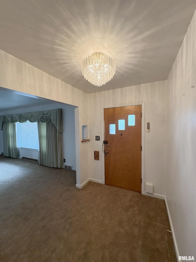 502 W Crestwood Dr, Peoria, IL 61614 - carpeted foyer entrance featuring a chandelier and baseboards