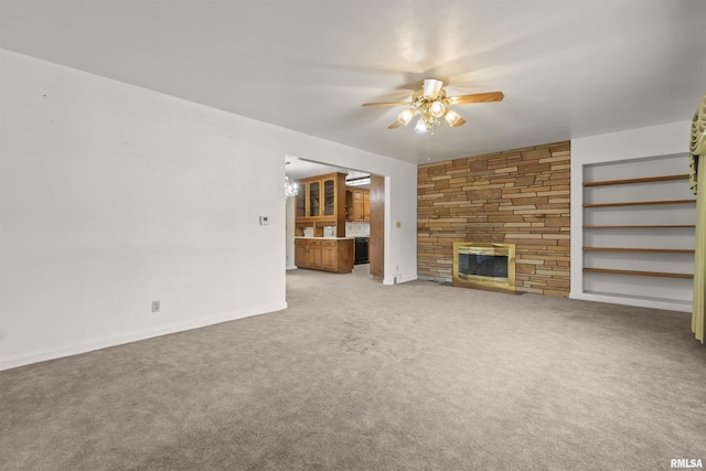 502 W Crestwood Dr, Peoria, IL 61614 - unfurnished living room featuring ceiling fan, light carpet, a fireplace, and built in features