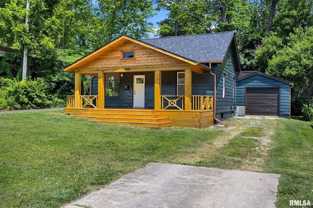 1431 E Rouse Ave, Peoria, IL 61614 - view of front of property featuring a porch, roof with shingles, dirt driveway, and a front yard