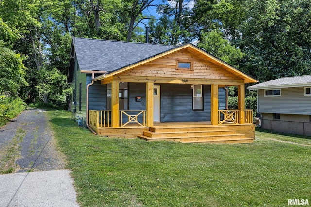 1431 E Rouse Ave, Peoria, IL 61614 - view of front of property with a shingled roof, a porch, a front yard, and driveway