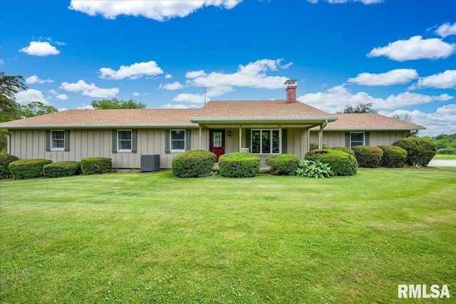 1522 N Stone School Rd, Elmwood, IL 61529 - single story home featuring a chimney, a front yard, and board and batten siding