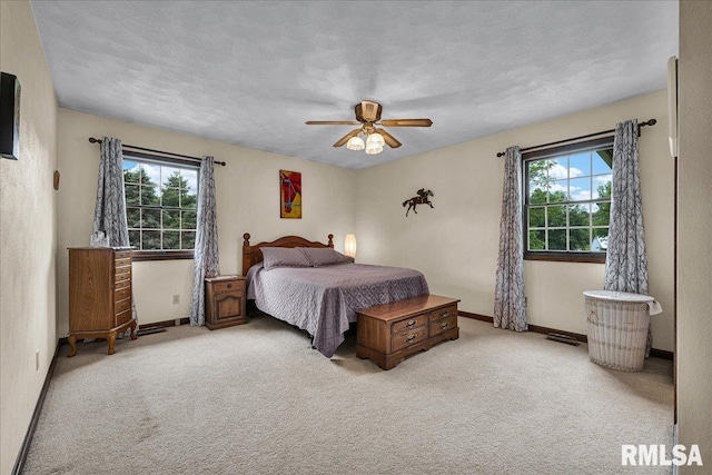 1522 N Stone School Rd, Elmwood, IL 61529 - carpeted bedroom featuring multiple windows and a ceiling fan