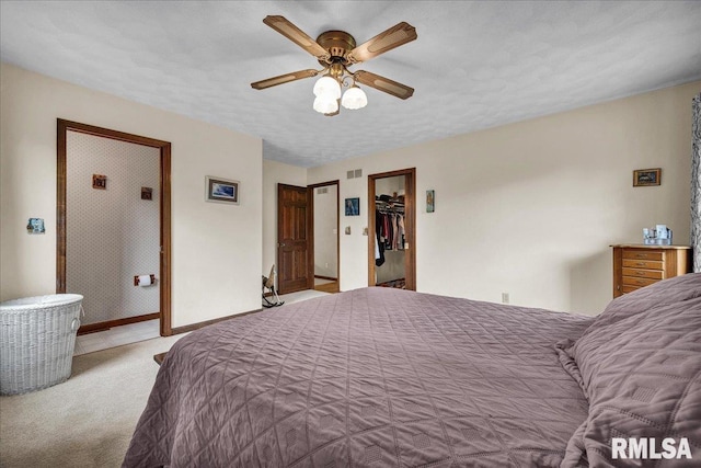 1522 N Stone School Rd, Elmwood, IL 61529 - carpeted bedroom featuring a ceiling fan and a walk in closet