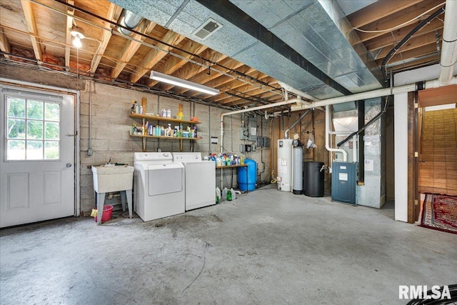 1522 N Stone School Rd, Elmwood, IL 61529 - below grade area featuring washing machine and dryer, gas water heater, a water pressure tank, a water softener, and heating unit