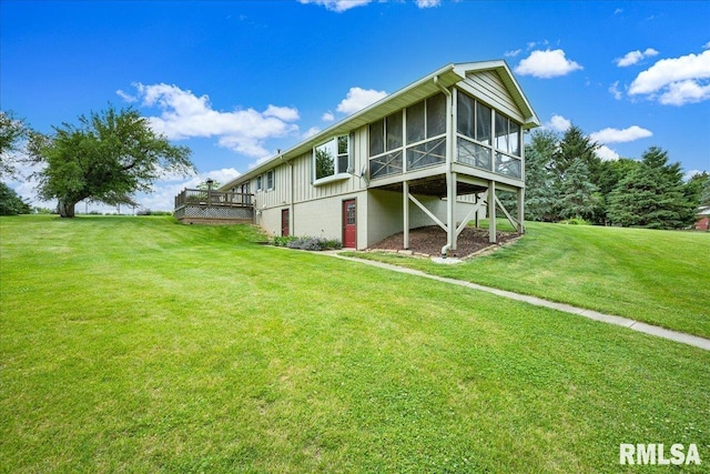 1522 N Stone School Rd, Elmwood, IL 61529 - back of property with a sunroom, a yard, and a deck