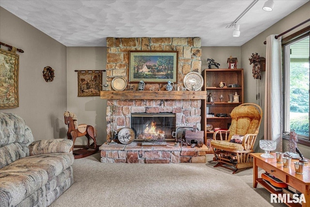 1522 N Stone School Rd, Elmwood, IL 61529 - carpeted living room featuring a fireplace, track lighting, and a textured ceiling