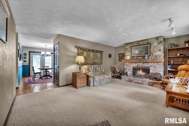 1522 N Stone School Rd, Elmwood, IL 61529 - living room with a chandelier, carpet flooring, and a stone fireplace