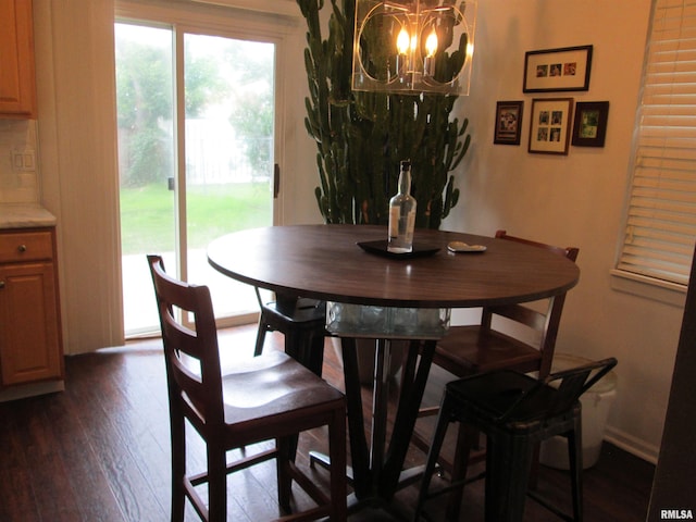 2010 W Westbrook Dr, Peoria, IL 61614 - dining area with a chandelier, dark wood finished floors, and plenty of natural light