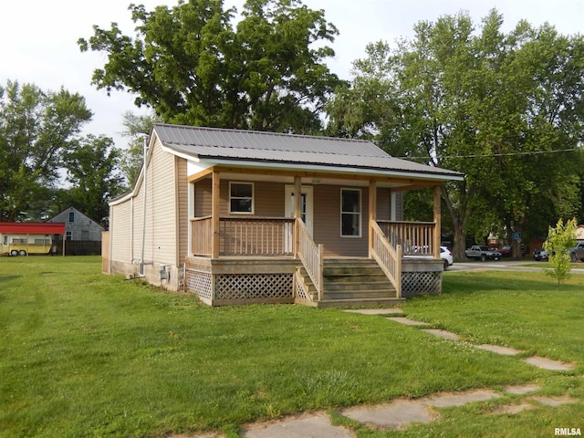 300 E Summer St, Plymouth, IL 62367 - view of front of property with a porch, a front yard, and a metal roof
