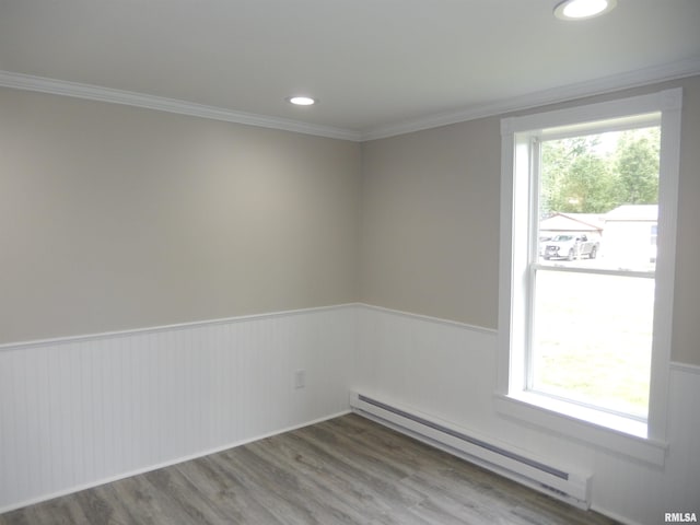 300 E Summer St, Plymouth, IL 62367 - unfurnished room with a baseboard radiator, wainscoting, crown molding, wood finished floors, and recessed lighting
