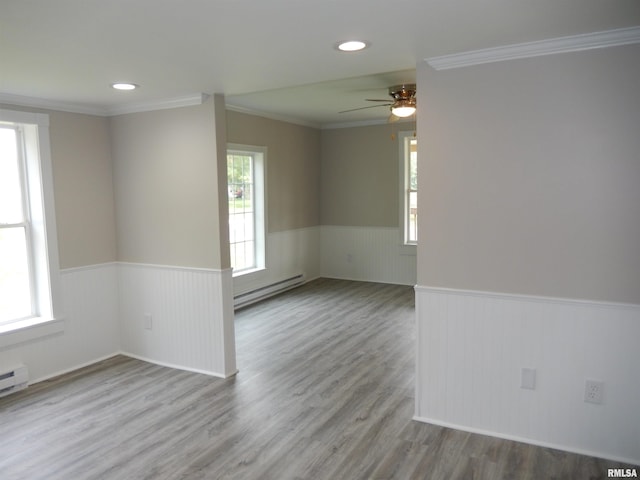 300 E Summer St, Plymouth, IL 62367 - unfurnished room with wainscoting, a baseboard heating unit, plenty of natural light, a ceiling fan, and ornamental molding