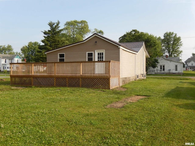 300 E Summer St, Plymouth, IL 62367 - rear view of property with a wooden deck, a yard, and a metal roof