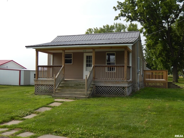 300 E Summer St, Plymouth, IL 62367 - back of property with a lawn, a metal roof, and a porch