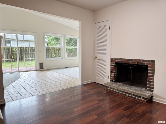 133 Holden Dr, Macomb, IL 61455 - unfurnished living room featuring wood finished floors and a fireplace