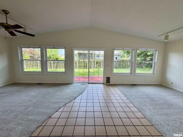 133 Holden Dr, Macomb, IL 61455 - spare room featuring light colored carpet, healthy amount of natural light, lofted ceiling, and a ceiling fan