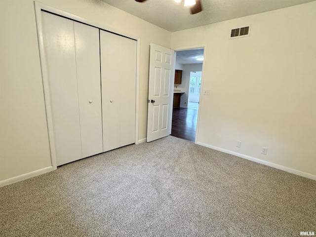 133 Holden Dr, Macomb, IL 61455 - unfurnished bedroom featuring carpet floors, a closet, and ceiling fan