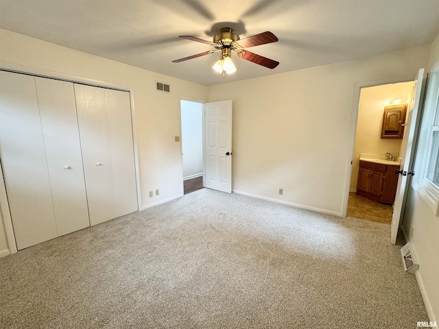133 Holden Dr, Macomb, IL 61455 - unfurnished bedroom with a closet, carpet flooring, a ceiling fan, and connected bathroom