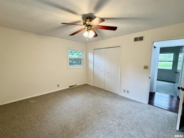 133 Holden Dr, Macomb, IL 61455 - unfurnished bedroom with dark carpet, a closet, and a ceiling fan