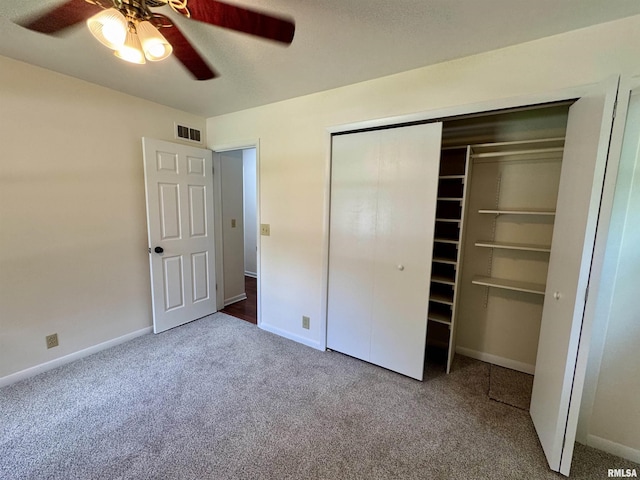 133 Holden Dr, Macomb, IL 61455 - unfurnished bedroom featuring carpet, a closet, and ceiling fan