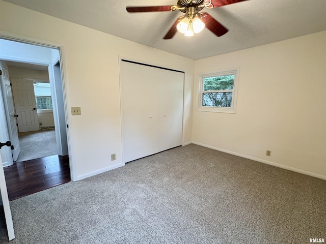 133 Holden Dr, Macomb, IL 61455 - unfurnished bedroom with carpet, a closet, multiple windows, and ceiling fan