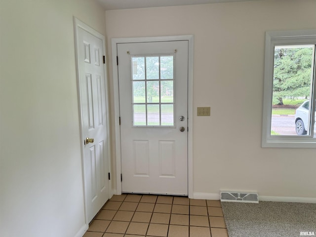 133 Holden Dr, Macomb, IL 61455 - doorway featuring baseboards and light tile patterned flooring