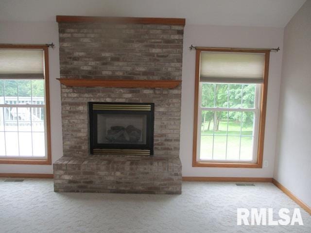 3708 Bloomington Rd, East Peoria, IL 61611 - unfurnished living room with carpet, healthy amount of natural light, and a fireplace