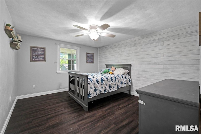 1536 Hickory Point Rd, Metamora, IL 61548 - bedroom featuring wood walls, dark wood-style flooring, a textured ceiling, and ceiling fan