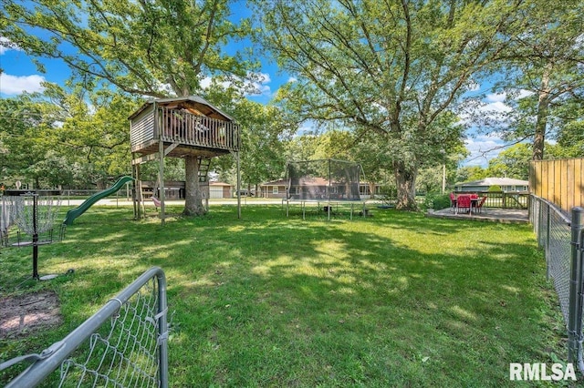 1536 Hickory Point Rd, Metamora, IL 61548 - fenced backyard featuring a trampoline and a playground