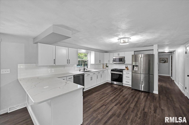 1536 Hickory Point Rd, Metamora, IL 61548 - kitchen with stainless steel appliances, light stone countertops, a textured ceiling, a peninsula, and decorative backsplash