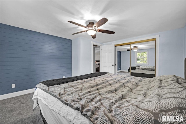 1536 Hickory Point Rd, Metamora, IL 61548 - carpeted bedroom featuring a closet, wooden walls, and a ceiling fan