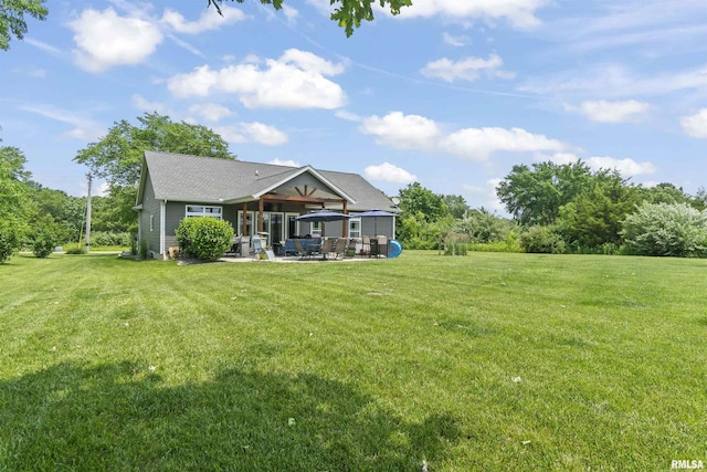 4096 Oak Run Dr, Dahinda, IL 61428 - back of house with a patio area, a yard, and a shingled roof