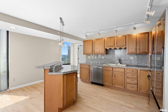 123 SW Jefferson St Unit E10C, Peoria, IL 61602 - kitchen featuring stainless steel dishwasher, track lighting, decorative backsplash, and light wood-style floors