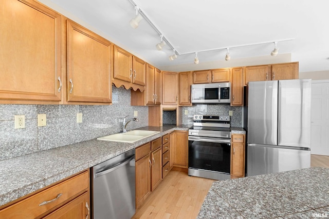 123 SW Jefferson St Unit E10C, Peoria, IL 61602 - kitchen with appliances with stainless steel finishes, tile countertops, light wood finished floors, and rail lighting