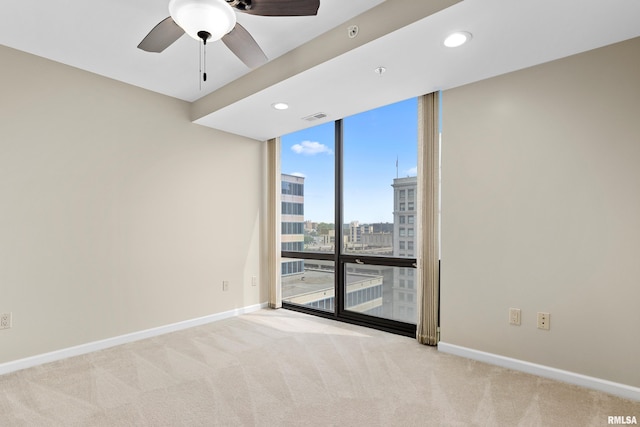 123 SW Jefferson St Unit E10C, Peoria, IL 61602 - unfurnished room with expansive windows, carpet floors, ceiling fan, a city view, and recessed lighting
