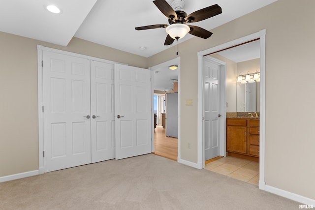 123 SW Jefferson St Unit E10C, Peoria, IL 61602 - unfurnished bedroom with light carpet, a closet, ensuite bathroom, a ceiling fan, and recessed lighting