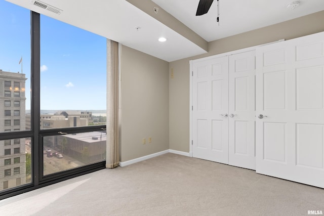 123 SW Jefferson St Unit E10C, Peoria, IL 61602 - unfurnished bedroom with carpet floors, a closet, and ceiling fan