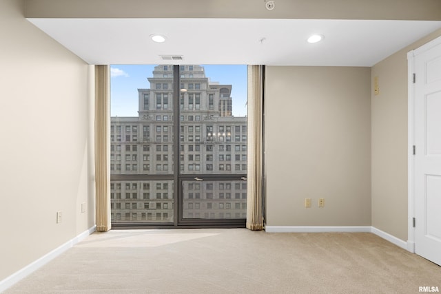 123 SW Jefferson St Unit E10C, Peoria, IL 61602 - spare room featuring carpet flooring and recessed lighting