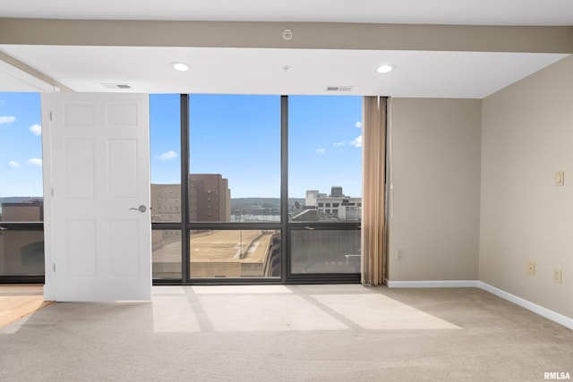 123 SW Jefferson St Unit E10C, Peoria, IL 61602 - empty room featuring carpet, a city view, recessed lighting, and floor to ceiling windows
