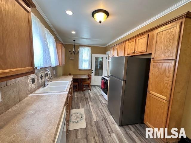 964 E Locust St, Canton, IL 61520 - kitchen with freestanding refrigerator, a chandelier, wood finished floors, crown molding, and light countertops