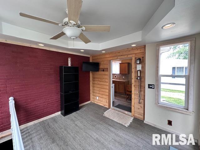 964 E Locust St, Canton, IL 61520 - interior space featuring recessed lighting, a tray ceiling, dark wood-type flooring, ceiling fan, and brick wall