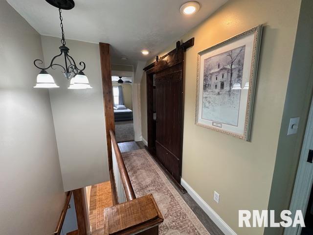 964 E Locust St, Canton, IL 61520 - hallway with a barn door, a chandelier, and recessed lighting
