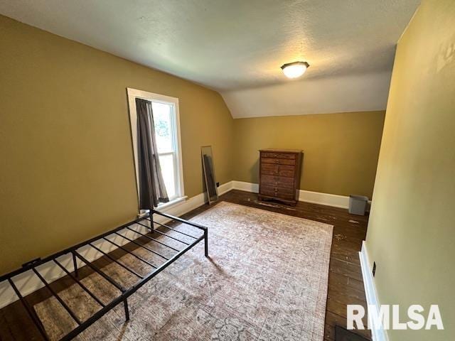 964 E Locust St, Canton, IL 61520 - unfurnished bedroom featuring lofted ceiling and wood finished floors