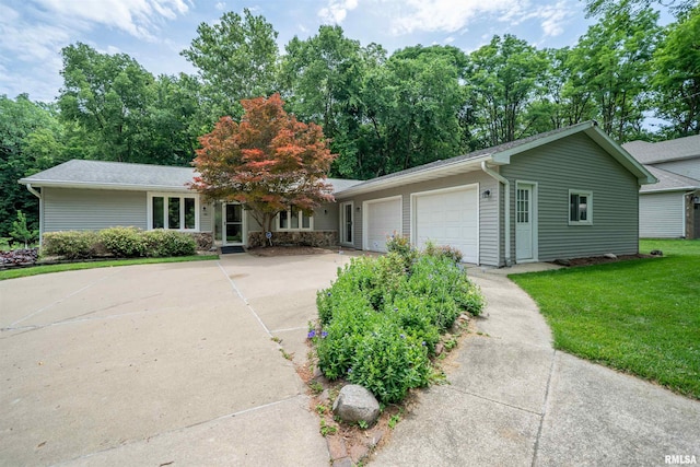 748 E Poplet Hollow Rd, Peoria, IL 61614 - ranch-style house with an attached garage, concrete driveway, and a front lawn