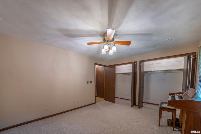 748 E Poplet Hollow Rd, Peoria, IL 61614 - unfurnished bedroom featuring two closets, light colored carpet, and ceiling fan