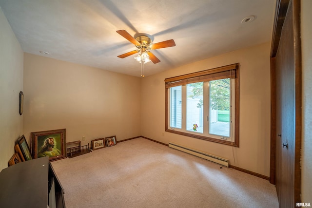 748 E Poplet Hollow Rd, Peoria, IL 61614 - unfurnished bedroom with a baseboard heating unit, carpet flooring, and ceiling fan