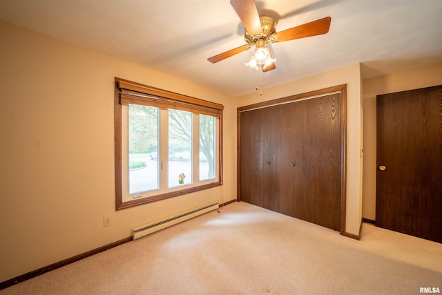 748 E Poplet Hollow Rd, Peoria, IL 61614 - unfurnished bedroom featuring baseboard heating, carpet flooring, a closet, and ceiling fan