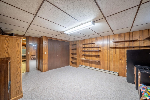 748 E Poplet Hollow Rd, Peoria, IL 61614 - finished basement featuring baseboard heating, wooden walls, carpet floors, and a paneled ceiling