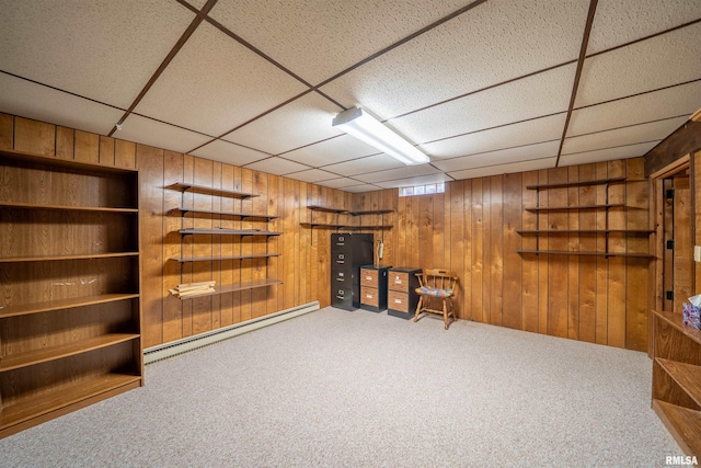 748 E Poplet Hollow Rd, Peoria, IL 61614 - basement with a baseboard radiator, a paneled ceiling, wood walls, and carpet floors