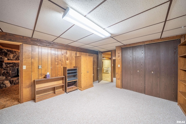 748 E Poplet Hollow Rd, Peoria, IL 61614 - unfurnished bedroom with carpet flooring, wooden walls, a paneled ceiling, and a closet